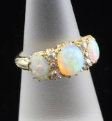 A late Victorian 18ct gold, white opal and diamond half hoop ring, size L.