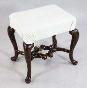 An 18th century style walnut stool, with a rectangular overstuffed seat, on cabriole legs united by
