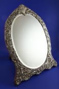 A large late Victorian silver mounted dressing table mirror, with oval plate, engraved inscription