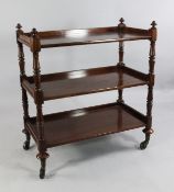 A 19th century mahogany three tier buffet, with turned uprights and brass castor feet, W.3ft