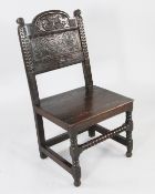A late 17th / early 18th century oak side chair, with carved and panelled back and solid seatFrom a
