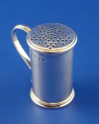 A George III silver sander, of cylindrical form with reeded loop handle and lid pierced in the form