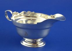 A George III silver sauceboat, with engraved armorial and cut rim, ?C, London, 1768, 6.5 oz.