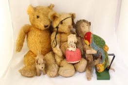 A small collection of toys, comprising two plush covered teddies, a small plush covered dog, a