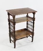 A Liberty Arts & Crafts oak three tier reading table, by Leonard Wyburd, with turned supports and