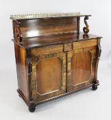 A Regency rosewood chiffonier, the single shelf superstructure with S scroll supports, above single