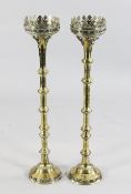 A pair of Gothic style pricket candlesticks, knop stem and circular bases, 33.5in.