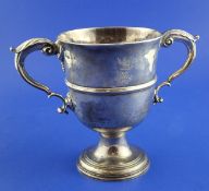 A George II Irish silver two handled cup, with engraved armorials, banded girdle and acanthus leaf