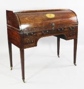 A 19th century plum pudding mahogany cylinder bureau, the fall inlaid with central oval paterae,