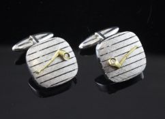 A pair of 18ct white gold cufflinks, each decorated with an applied yellow gold pipe set with a