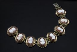 An early 20th century continental 800 standard silver gilt and cameo bracelet, with eight oval