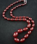 A single strand simulated oval red amber bead necklace, 32in.