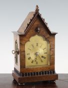 An early Victorian rosewood mantel timepiece, with gothic arched case and gilt dial signed T.Cox