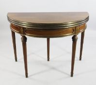 A Louis XVI style mahogany and ormolu mount triple folding demi lune games table, with pull out