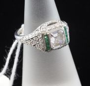 An Art Deco style platinum, emerald and diamond set cluster ring, the central stone weighing 0.