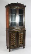 A Regency gonzalo alves ebony inlaid cabinet, attributed to George Bullock, fitted with a pair of