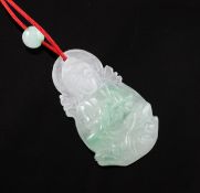A semi translucent jadeite pendant carved in the form of Guanyin. on a string necklace with single