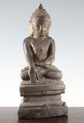 A Thai carved giltwood seated figure of Buddha, 19th century, on a shaped throne, 37.5cm.