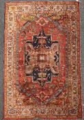 A Turkish rug, with central shaped medallion containing stylised motifs in a shaped foliate field,