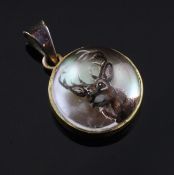 A late Victorian gold mounted Essex crystal pendant, decorated with the head of a stag, of circular