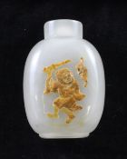 A Chinese cameo chalcedony snuff bottle, of ovoid form, carved in relief to a russet inclusion in