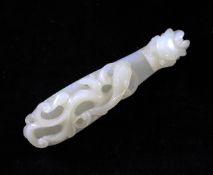 A Chinese pale celadon jade belt hook, 19th century, carved in high relief with a scrolling chi-