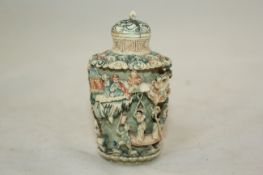 A coloured ivory snuff bottle and stopper, Japanese, early 20th century, of tapering oval section,