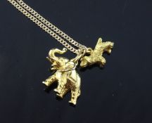 A 14ct gold chain hung with two 14ct gold charms, dog and elephant, chain 18.5in.
