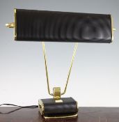 Attributed to Eileen Gray. A French gilt and black lacquered metal desk lamp, 18in.