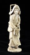 A Japanese ivory figure of a woman holding a root vegetable, early 20th century, with two chicks at