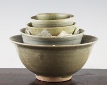 Five Thai Sawankhalok celadon bowls, 14th / 15th century, of graduated size, the largest with an