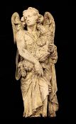 An 18th century European carved oak model of an angel holding a lamb, 28.25in.
