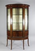 An Edwardian mahogany, ebony and boxwood line inlaid D shaped display case, with single door, on