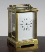 An Edwardian brass hour repeating carriage clock, with enamelled Roman dial, 5.5in., with