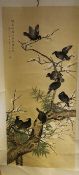 A 20th century Chinese painting on silk, of crows amid prunus and bamboo branches, inscribed upper