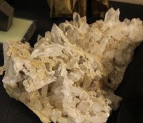 A large rock crystal cluster specimen, comprising approximately one hundred polished prisms of