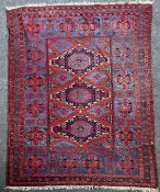 An early 20th century Turkish carpet, with three central shaped polygons in a geometric field, on a