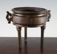 A Chinese bronze tripod censer, of drum form, cast in relief to a central band with six characters,