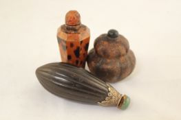 Three Chinese snuff bottles, late 19th / early 20th century, the first a palm nut with engraved