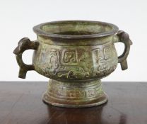 A Chinese verdigris bronze two handled censer, in archaistic style, cast in relief with taotie