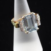 A two colour gold, aquamarine and diamond set dress ring, size L.