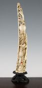 A Chinese ivory figure of Shou Lao, early 20th century, the standing figure holding a peach in his