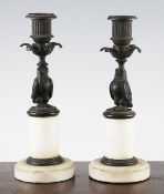 A pair of 19th century bronze and white marble candlesticks, each with a central owl column, on