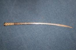 An 18th / 19th century continental sabre, with a crossed hatched ivory grip, the steel blade etched