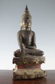 A Thai carved giltwood seated figure of Buddha, 19th century, on a shaped throne, with some