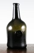 An English glass sealed wine bottle, dated 1779, the seal inscribed `J Beague 1779`, 10in.