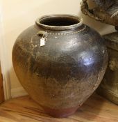 Two large Burmese ovoid glazed stoneware storage jars, H.2ft 11in. x W.2ft 7in.