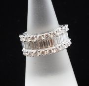 An 18ct white gold and diamond cluster half hoop dress ring, with central band of baguette cut