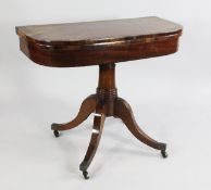 A George III mahogany and rosewood crossbanded folding card table, with swivel top, on central ring
