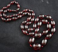 A graduated simulated red amber bead necklace, 40in.